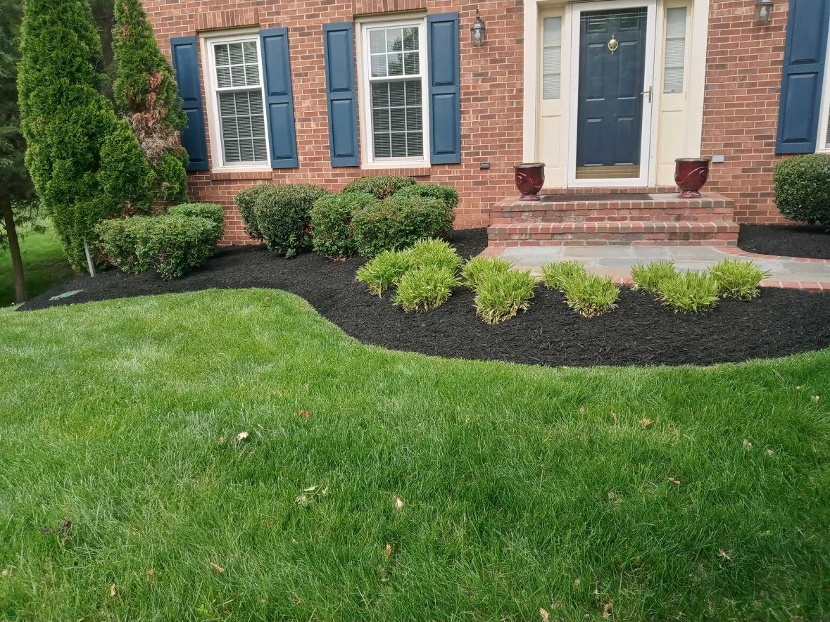 Curved foundation bed along a brick home