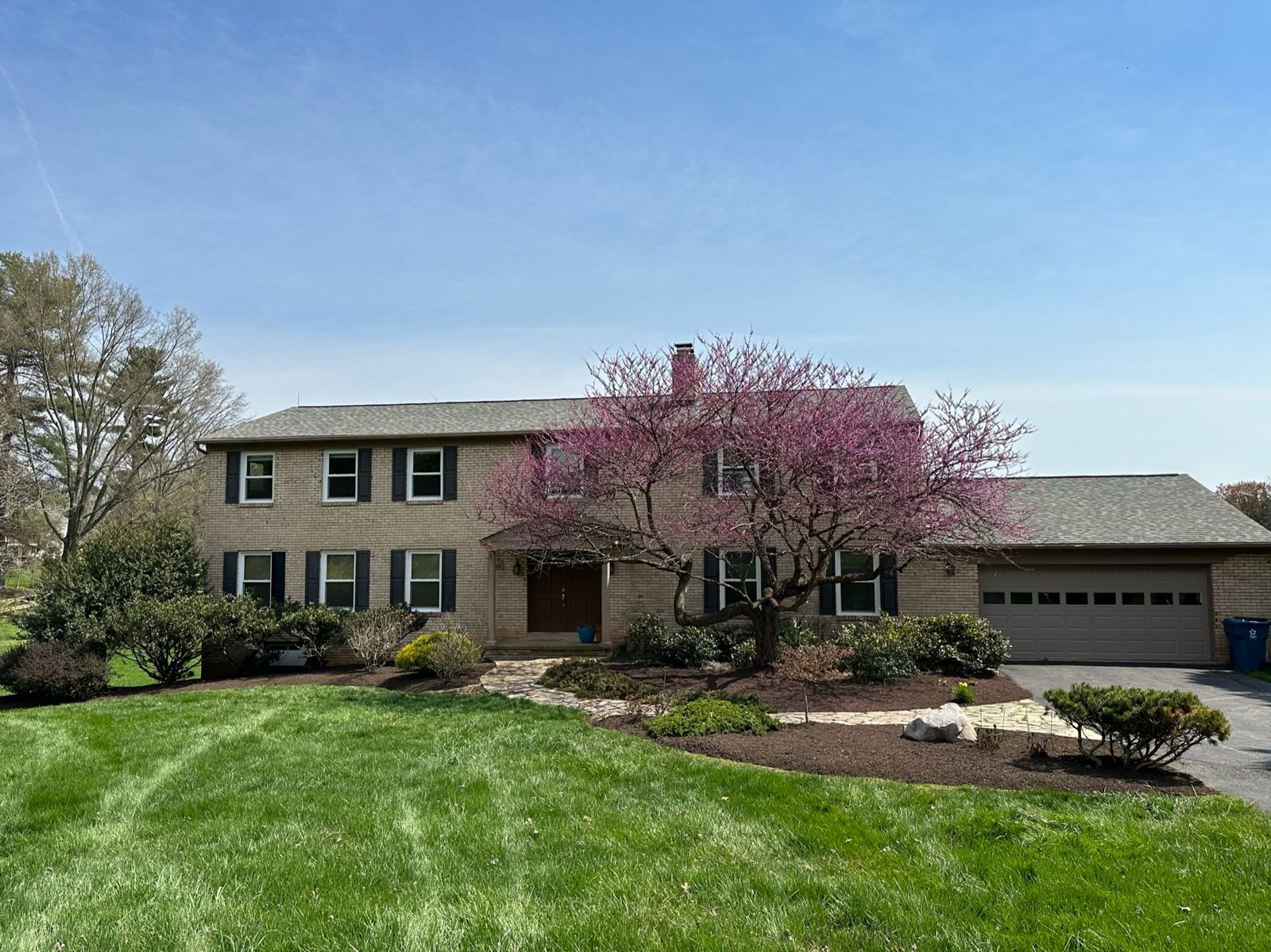 Home with a flowering redbud