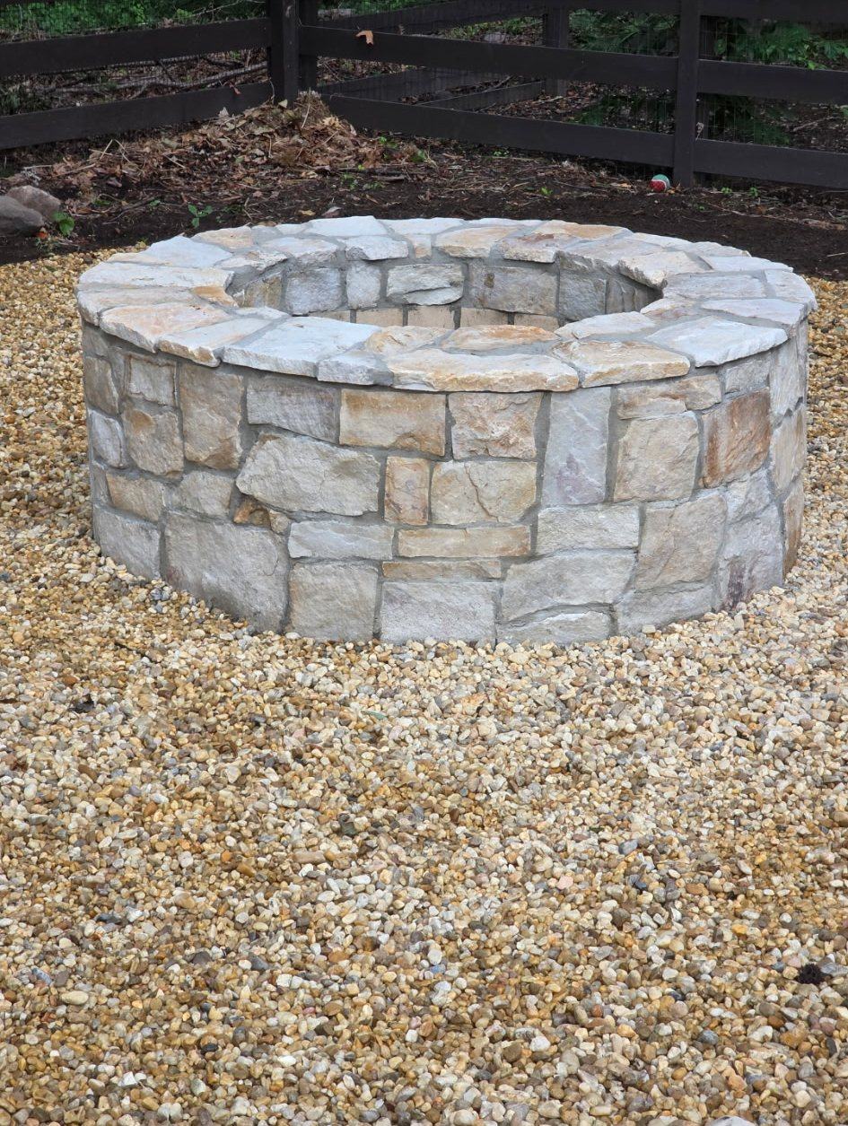 Natural stone fire pit on river gravel