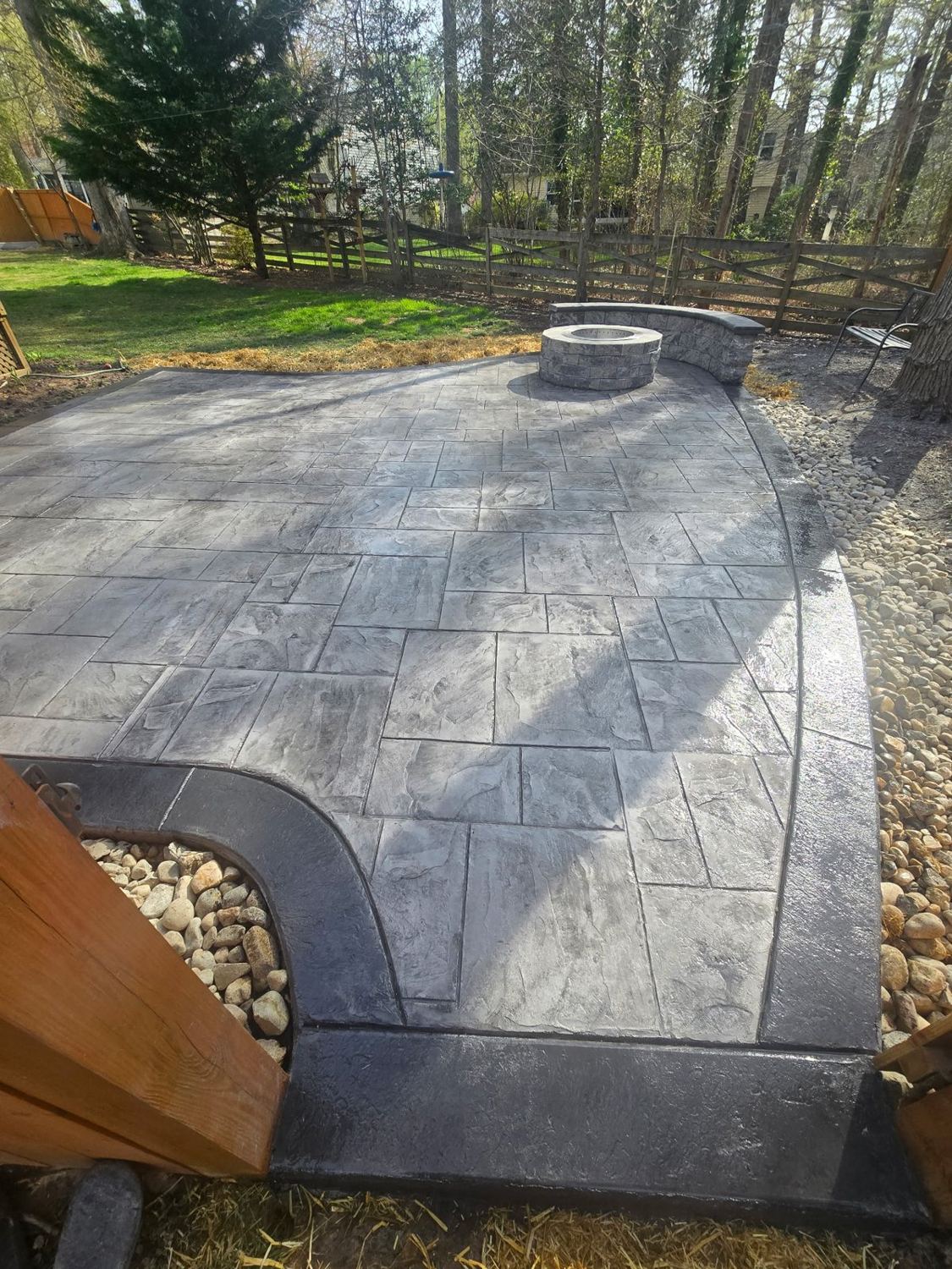 Stamped patio with built-in fire pit and seat wall